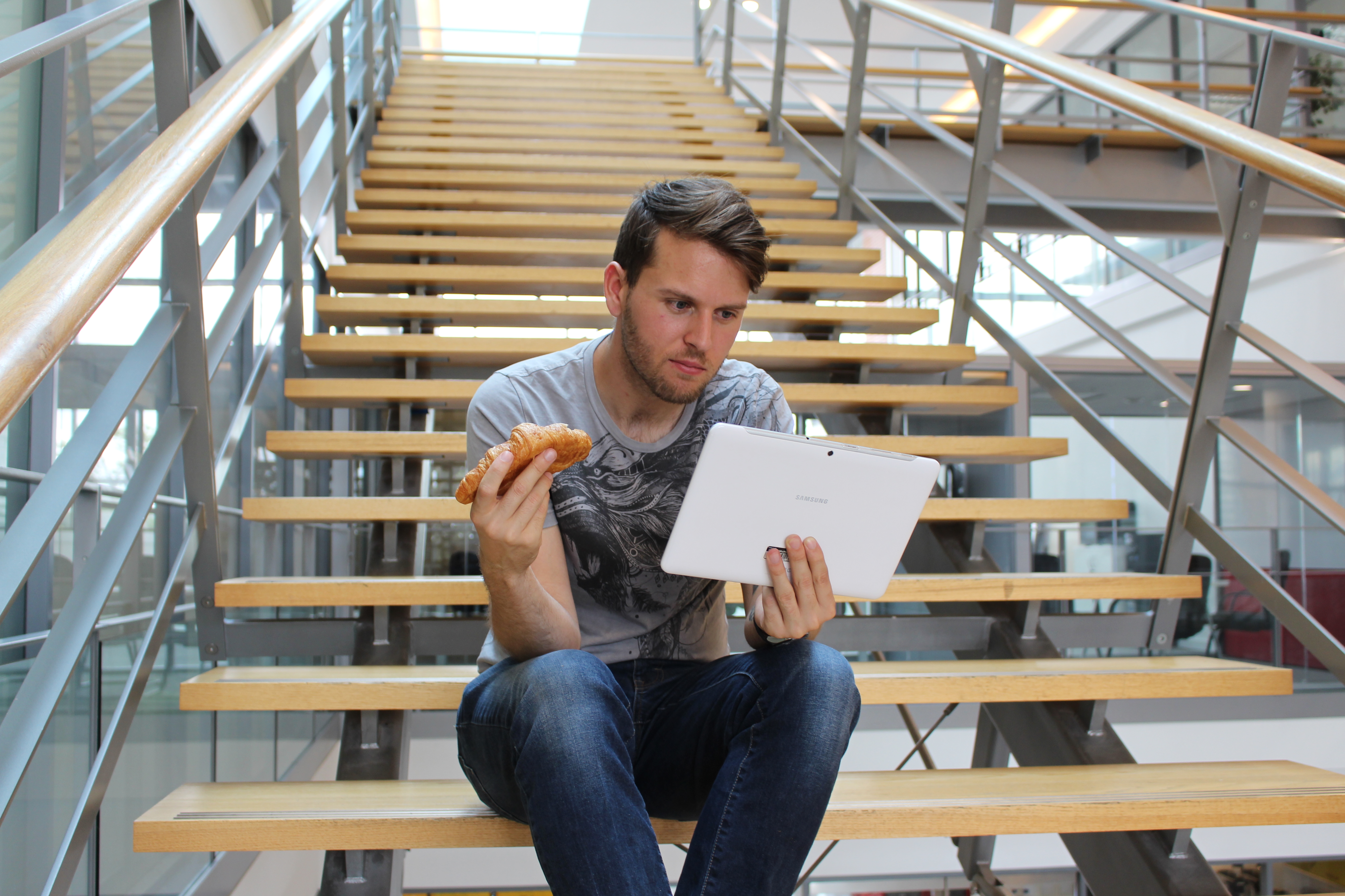 Eating a croissant on the office stairs