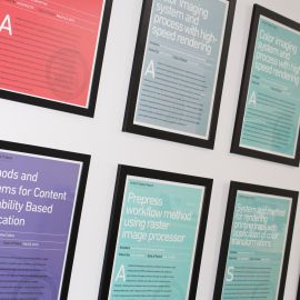 Framed patent certificates mounted on office wall